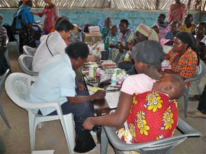 Indonesian Doctor and Kenyan, dispensing medications at makeshift pharmacy